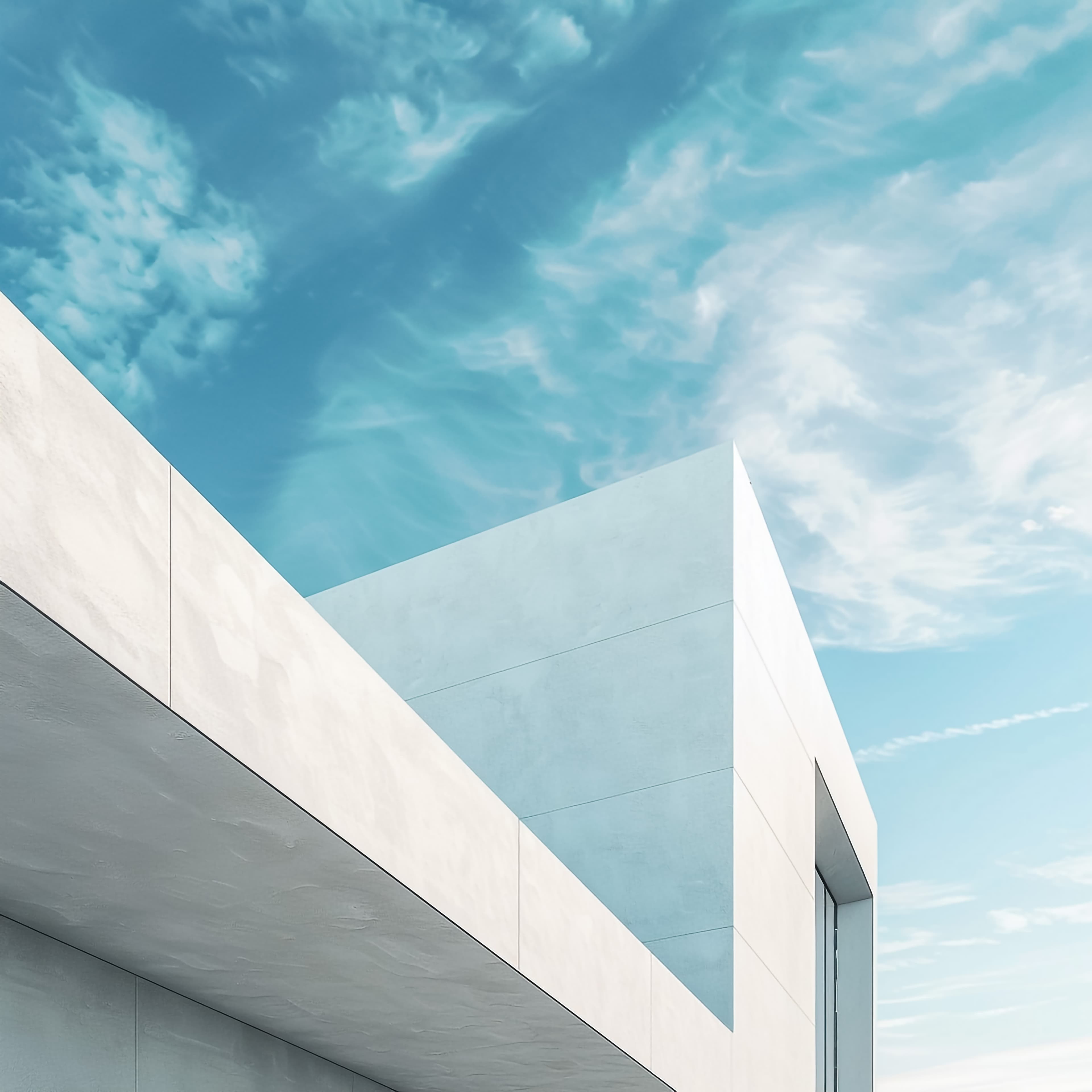 Minimal modern architecture with clean white lines under a blue sky